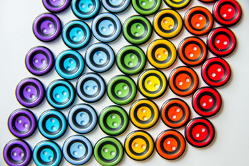 colorful round buttons on a white background, the color of the rainbow.