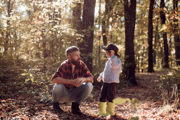 My dad cowboy. Hipster bearded dad with cute son spend time together in forest. Family time. Family...