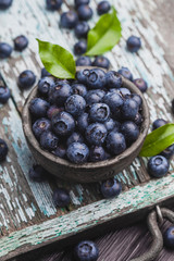 ripe blueberry berries on old wooden table. healthy food