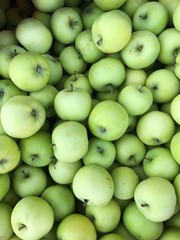 Delicious green apples in a box on the market
