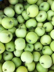 Delicious green apples in a box on the market