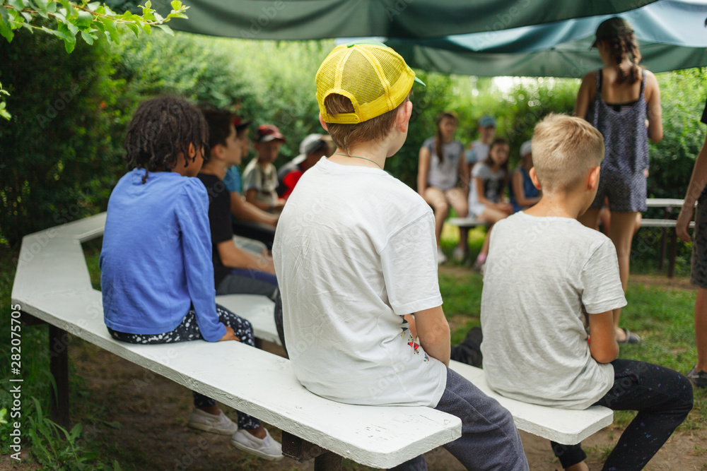 Wall mural meeting of children for a game in the camp in a summer sunny day