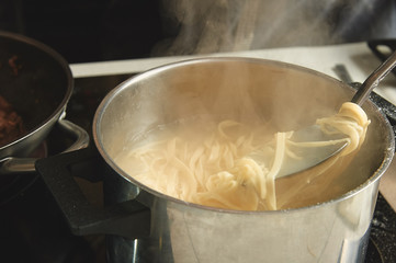 raw wok noodles cook in a pan