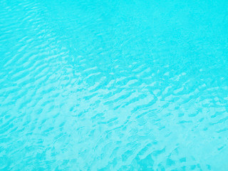 Blue background of water in swimming pool.