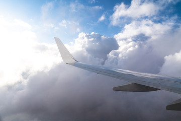 Fototapeta na wymiar Wing of a Plane on Blue Sky Background.