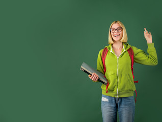 Portrait of creative young smiling female Student in glasses. Smiling girl student or woman teacher portrait on green wall blackboard background. Thank You Teacher.