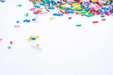 Colorful candy sprinkles close up for birthday cake on white background