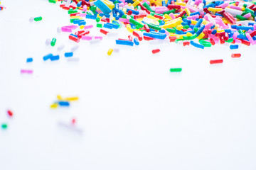 Colorful candy sprinkles close up for birthday cake on white background