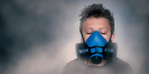 Young boy wearing gasmask, respirator portrait. Effects of worldwide air pollution, industrial...