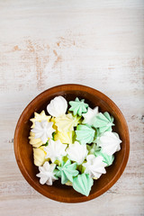 Meringue in a bowl on a wooden background