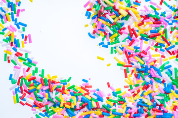 Colorful candy sprinkles close up for birthday cake on white background