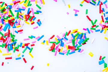 Colorful candy sprinkles close up for birthday cake on white background