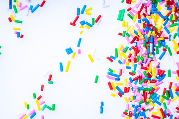 Colorful candy sprinkles close up for birthday cake on white background