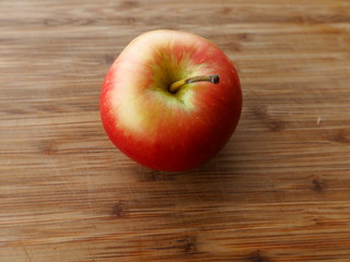 Juicy ripe apple on a wooden board