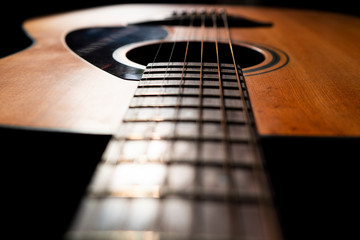 Obraz premium Acoustic guitar detail on black background