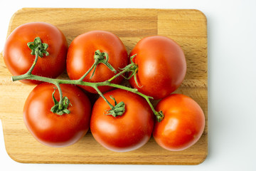Fresh organic red tomatoes on white background. Selective focus.