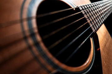 Acoustic guitar detail on black background