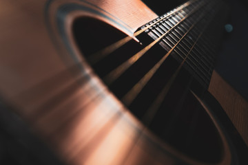 Acoustic guitar detail on black background - obrazy, fototapety, plakaty
