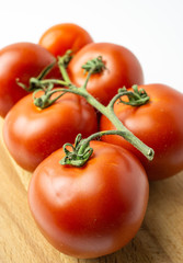 Fresh organic red tomatoes on white background. Selective focus.