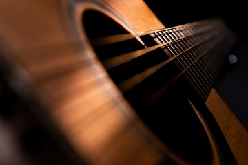 Acoustic guitar detail on black background