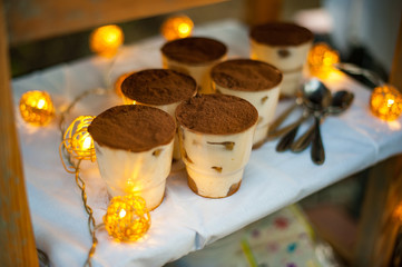 Tiramisu dessert with garlands. Party time decoration