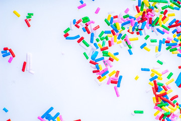 Colorful candy sprinkles close up for birthday cake on white background