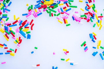 Colorful candy sprinkles close up for birthday cake on white background
