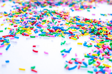 Colorful candy sprinkles close up for birthday cake on white background