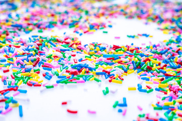 Colorful candy sprinkles close up for birthday cake on white background