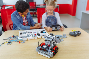 Mixed Racial group of School kids sitting at class with diy robot, stem education concept.