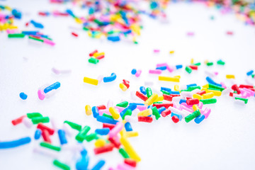 Colorful candy sprinkles close up for birthday cake on white background