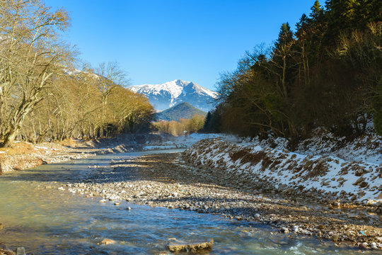 Karpenisiotis river with mountain Velouchi covered with snow in background, Karpenisi, Greece