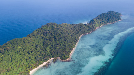 Aerial View of Tropical island named Koh Kradan in Trang, Thailand showing the coral reef along the island