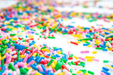 Colorful candy sprinkles close up for birthday cake on white background