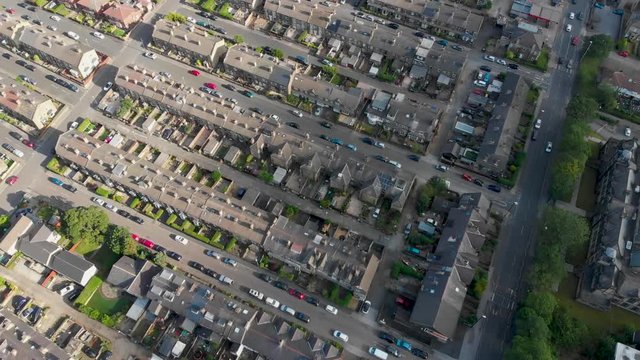 Aerial footage of the Leeds town of Pudsey in West Yorkshire, England showing typical British streets and business taken on a sunny bright summers day.