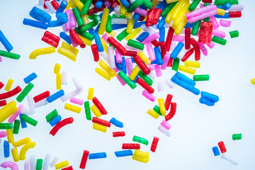 Colorful candy sprinkles close up for birthday cake on white background