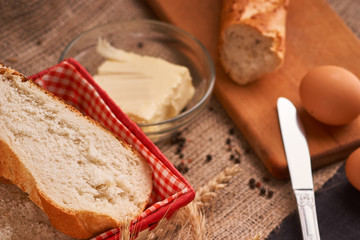 Different bread and wheat on the rustic table. Selective focus, close up