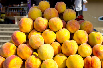Peach fruit close-up. Texture background of sweet yellow ripe peaches. Fruit Peaches Food Image