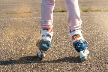 Fototapeta na wymiar Little girl on roller skates