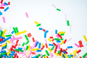 Colorful candy sprinkles close up for birthday cake on white background