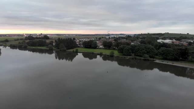 Aerial footage of the famous Leeds and Bradford airport located in the Yeadon area of West Yorkshire in the UK, typical British airport showing the runway and houses and roads around the airport