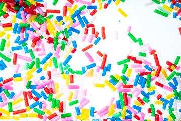 Colorful candy sprinkles close up for birthday cake on white background