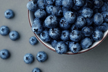 Fresh selected blueberries in bowl on dark gray table background