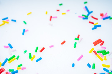 Colorful candy sprinkles close up for birthday cake on white background