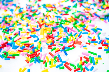 Colorful candy sprinkles close up for birthday cake on white background