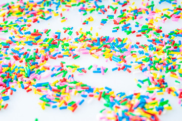 Colorful candy sprinkles close up for birthday cake on white background