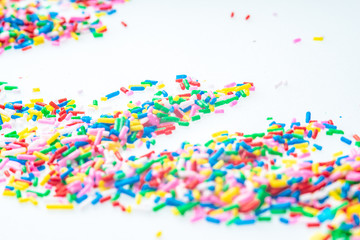 Colorful candy sprinkles close up for birthday cake on white background