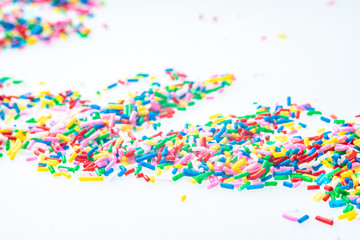 Colorful candy sprinkles close up for birthday cake on white background