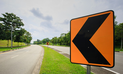 Traffic sign turn left curve and road in the forest