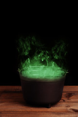 black halloween cauldron with green smoke